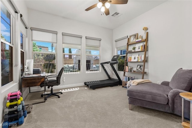 exercise room with ceiling fan and carpet floors