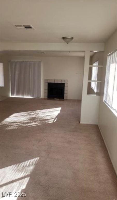 unfurnished living room featuring carpet flooring