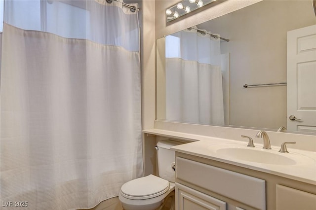 bathroom with vanity, curtained shower, and toilet