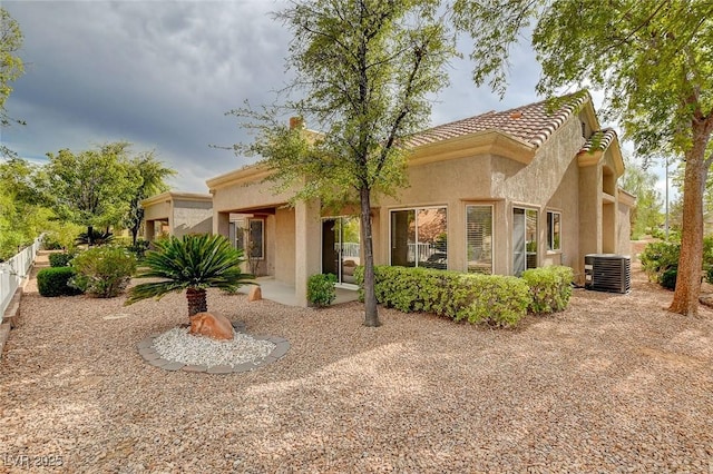 view of front of home featuring a patio area and central air condition unit