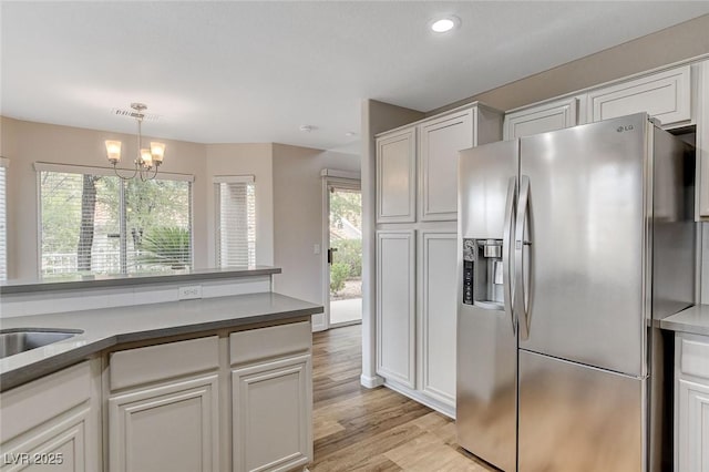 kitchen with white cabinetry and stainless steel refrigerator with ice dispenser