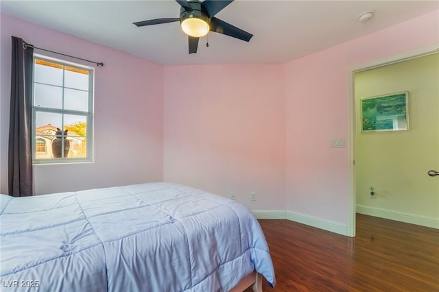 bedroom with dark hardwood / wood-style floors and ceiling fan