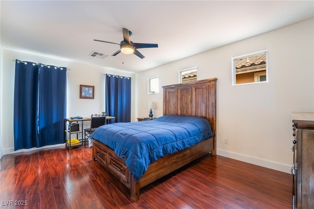 bedroom featuring visible vents, baseboards, ceiling fan, and dark wood finished floors