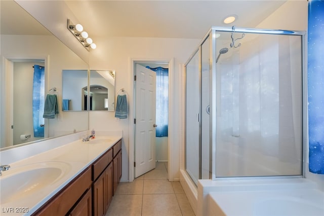 full bathroom featuring a shower stall, tile patterned floors, a sink, and double vanity