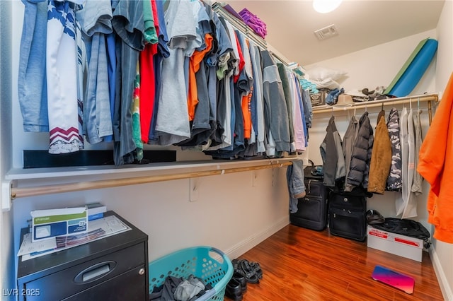 walk in closet with wood finished floors and visible vents