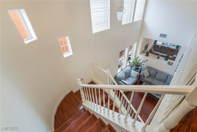 stairs featuring visible vents and a high ceiling