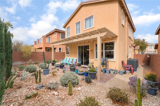 back of house with a pergola, a tiled roof, central AC unit, and stucco siding