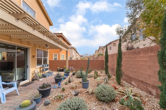 view of yard with a pergola, a fenced backyard, and a patio area