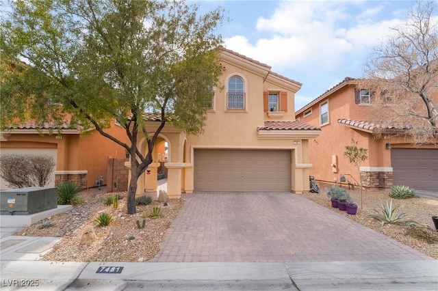 mediterranean / spanish-style home with a garage