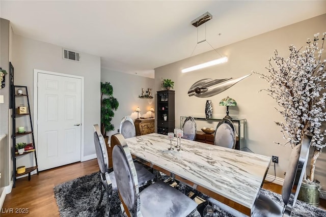 dining space featuring hardwood / wood-style floors