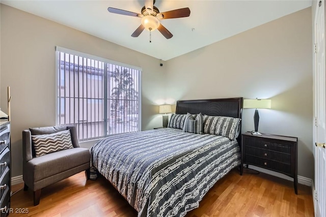 bedroom with ceiling fan and wood-type flooring