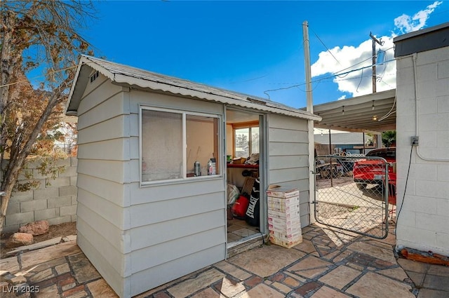 632 D, Boulder City, NV 89005 - view of outdoor structure featuring fence, an attached carport, and an outdoor structure