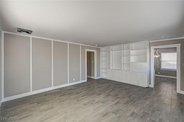 interior space featuring hardwood / wood-style flooring and ornamental molding