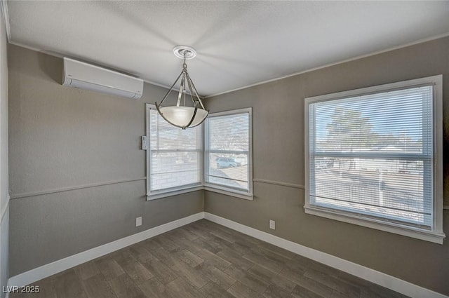 unfurnished dining area featuring a wall mounted air conditioner, dark wood-type flooring, and a healthy amount of sunlight