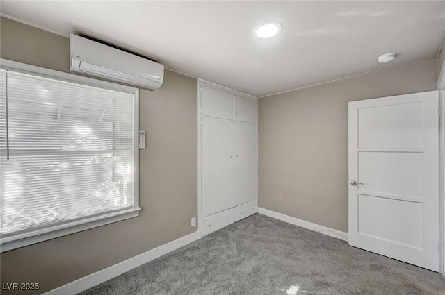 unfurnished bedroom with light colored carpet, a wall mounted AC, and a closet