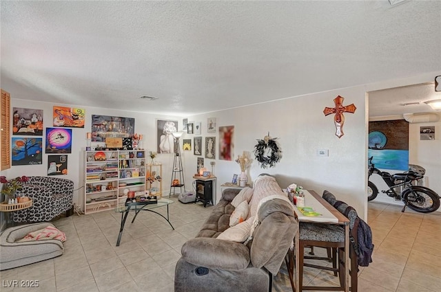 living room featuring a textured ceiling and light tile patterned floors