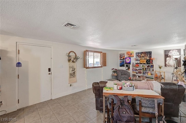 dining space with a textured ceiling and light tile patterned floors