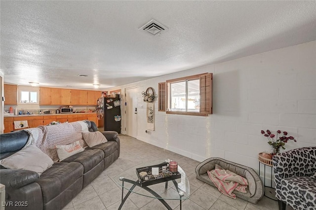 tiled living room with a textured ceiling