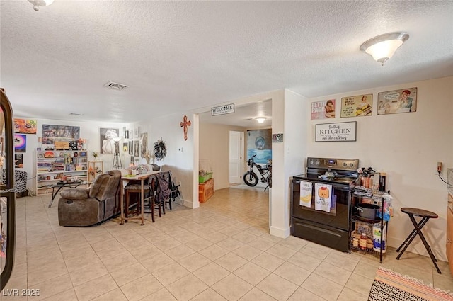 living room with light tile patterned floors and a textured ceiling