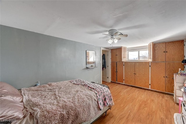 bedroom with ceiling fan and light hardwood / wood-style flooring