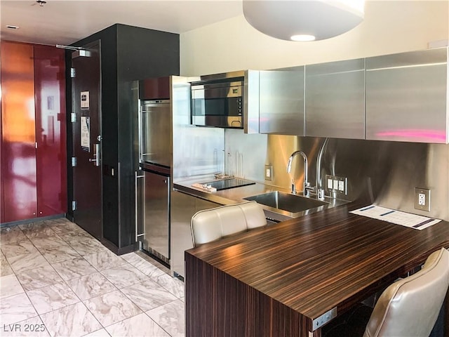 kitchen featuring black electric cooktop and sink