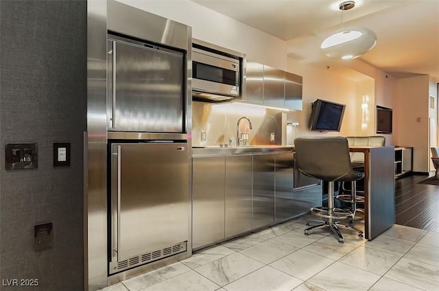 kitchen featuring sink, stainless steel appliances, and stainless steel counters