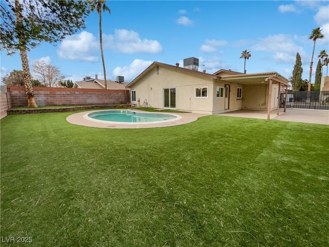 back of property featuring a fenced in pool, a yard, cooling unit, and a patio area