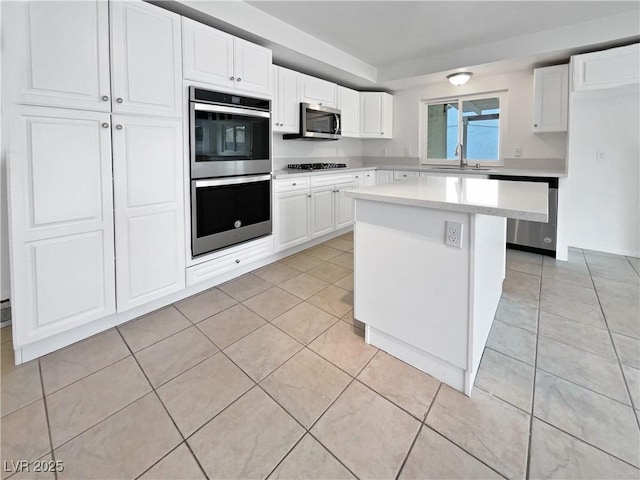 kitchen featuring white cabinetry, appliances with stainless steel finishes, and sink