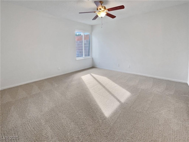 unfurnished room with ceiling fan and carpet