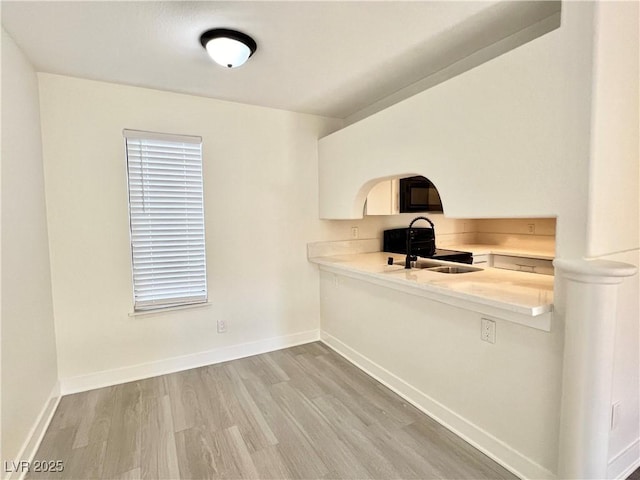 kitchen featuring sink and light wood-type flooring