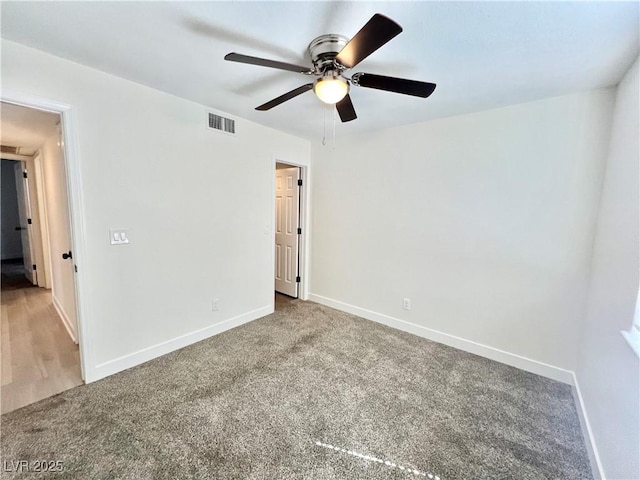 spare room featuring carpet floors and ceiling fan