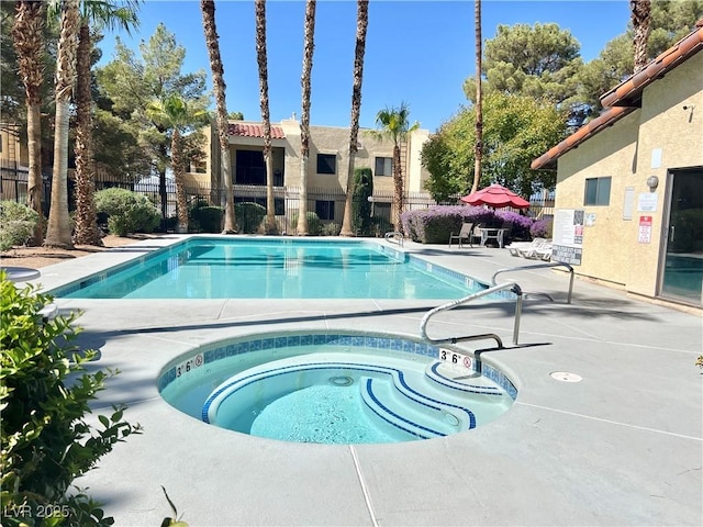 view of pool featuring a community hot tub and a patio area