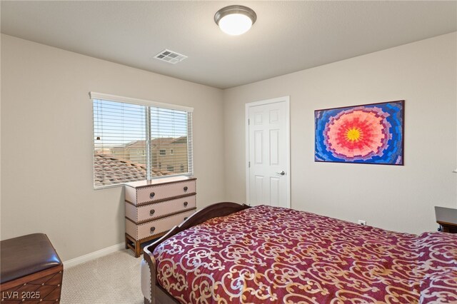 carpeted bedroom with visible vents and baseboards