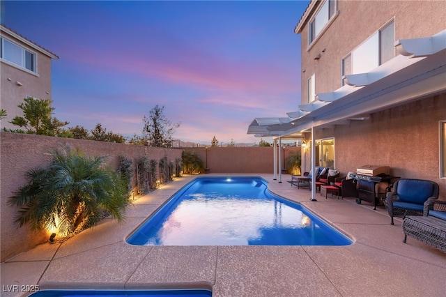 view of pool with a fenced in pool, area for grilling, a fenced backyard, and a patio area