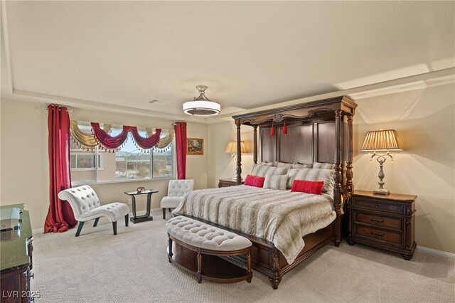 bedroom with visible vents, light carpet, and baseboards