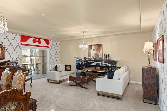 carpeted living room with an inviting chandelier