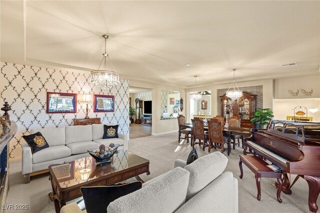 carpeted living room with a chandelier