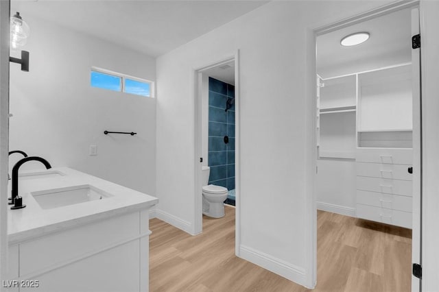 bathroom with vanity, hardwood / wood-style floors, and toilet