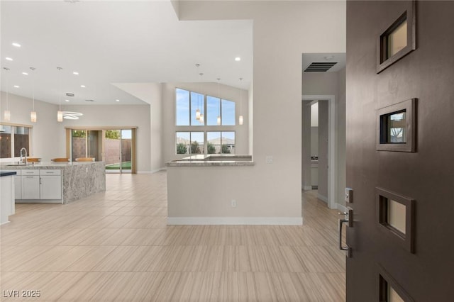 foyer featuring sink and light tile patterned floors