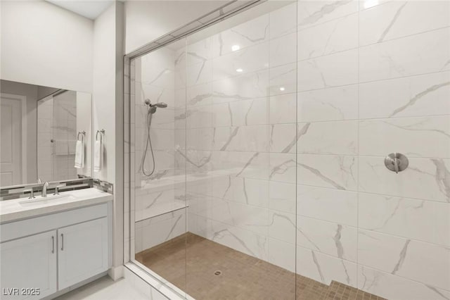 bathroom with vanity and tiled shower