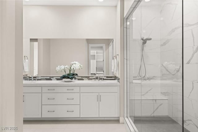 bathroom featuring a shower with door, vanity, and tile patterned flooring