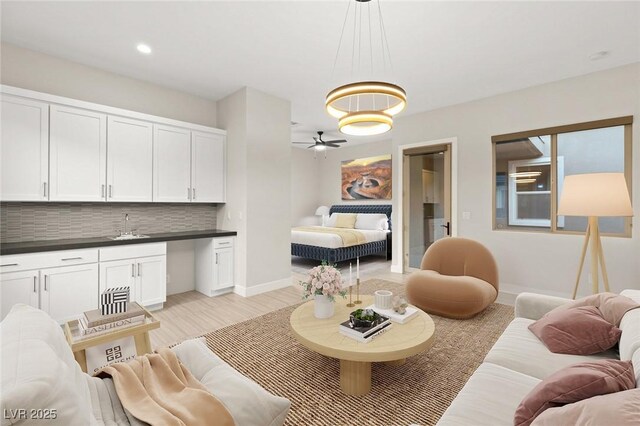 living room featuring sink and light hardwood / wood-style floors