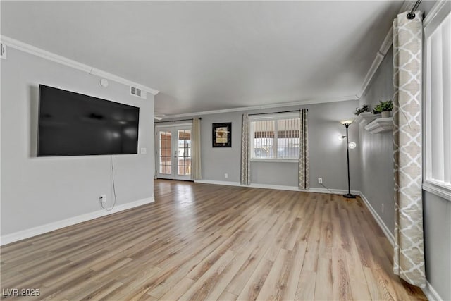 unfurnished living room with light hardwood / wood-style floors, ornamental molding, and french doors