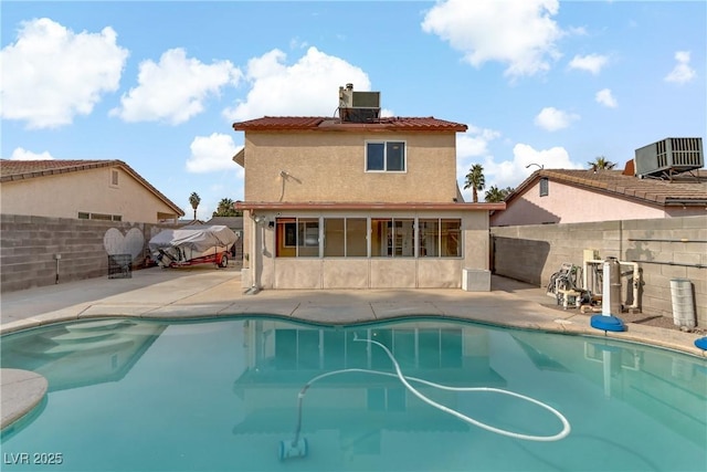 view of swimming pool featuring a patio and central air condition unit