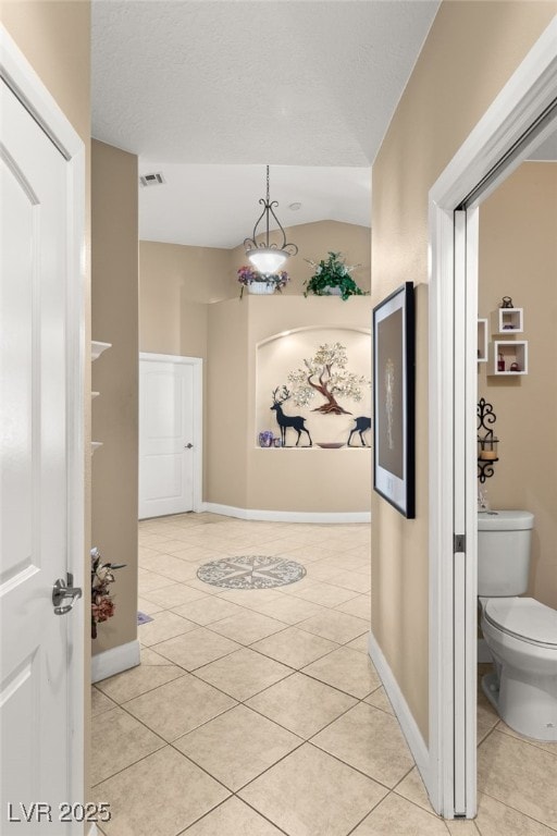 hallway featuring light tile patterned flooring