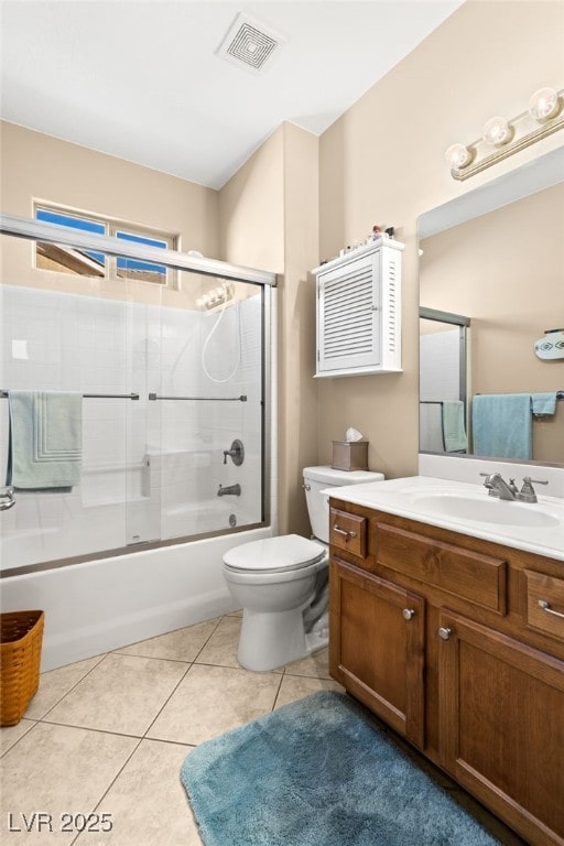 full bathroom with vanity, tile patterned floors, toilet, and combined bath / shower with glass door