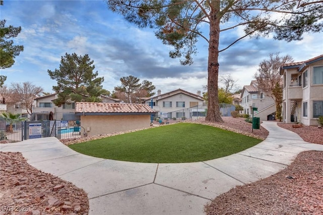 view of community with a pool and a lawn