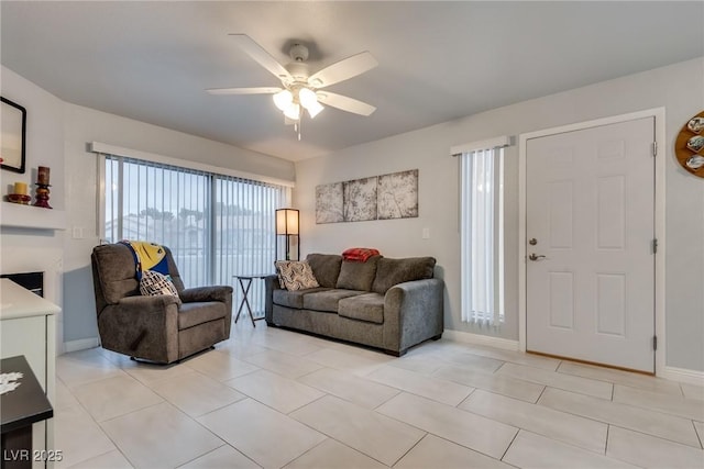 living room featuring light tile patterned floors and ceiling fan