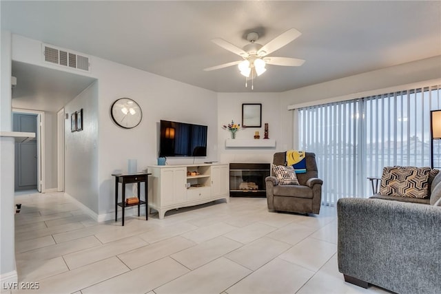 living room with ceiling fan and light tile patterned floors