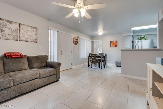 tiled living room with ceiling fan